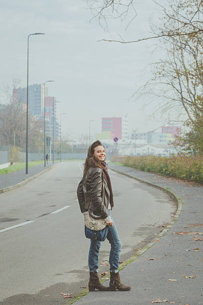 istock Beautiful young brunette posing in the city streets 468051260