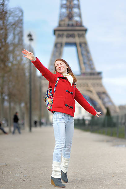 istock Young woman having fun near the Eiffel tower 468051598