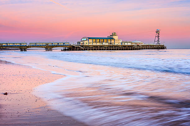 Bournemouth pier sunset Bournemouth pier at Sunset from beach Dorset England UK Europe bournemouth england photos stock pictures, royalty-free photos & images