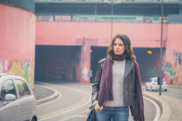 istock Beautiful young brunette posing in the city streets 468052710