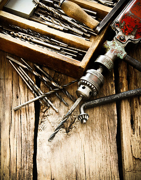 istock Old drill, box with drills on wooden background 468058958