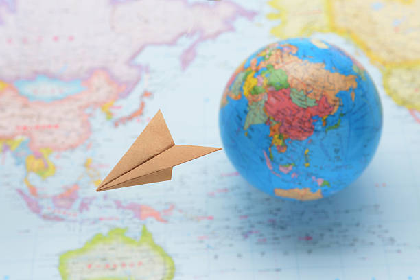istock Global business image, paper airplane flying over world map 468059402
