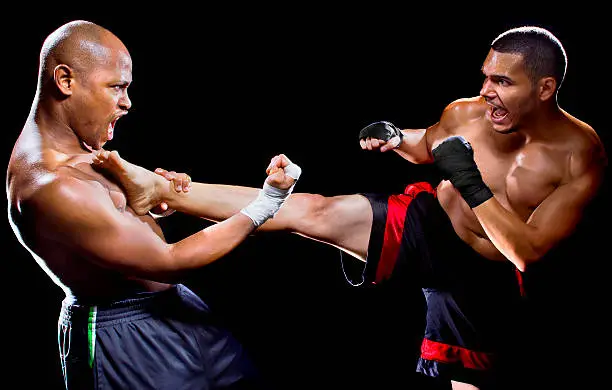 mma fighter performing a counter attack from a kick