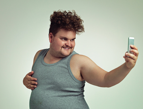 Shot of an overweight man taking a selfie with his phonehttp://195.154.178.81/DATA/istock_collage/0/shoots/783848.jpg