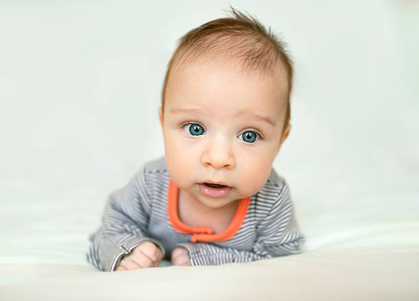 istock Beautiful baby boy lying on a bed 468067770