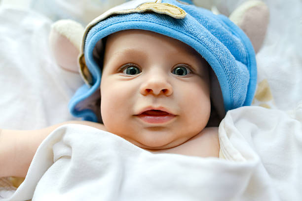 istock Beautiful baby lying on his back wrapped in a towel 468067792