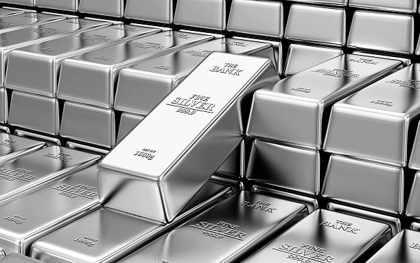 Stack of shiny silver bars inside a bank vault stock photo
