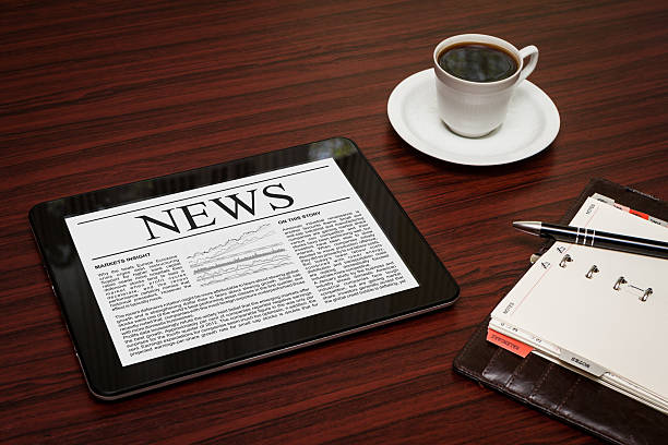 istock Reading the news on a tablet with a cup of coffee 468069909