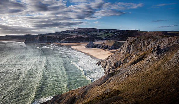 Three Cliffs Bay Gower Three Cliffs Bay on the south coast of the Gower peninsular in Swansea, south Wales. gower peninsular stock pictures, royalty-free photos & images