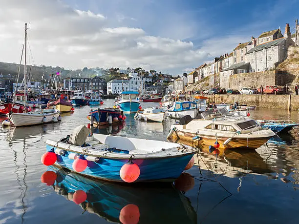 Small fishing boats in the historic harbour at Mevagissey Cornwall England UK Europe