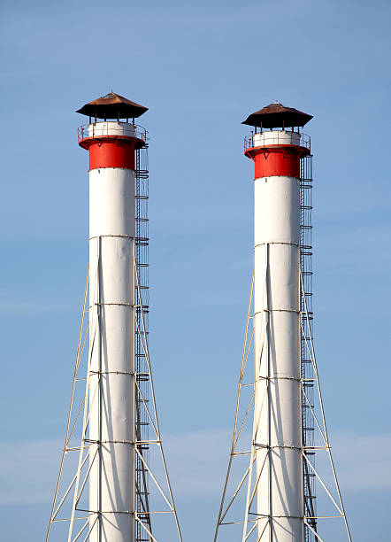 istock Industrial smoke pipes over blue sky vertical view 468081342