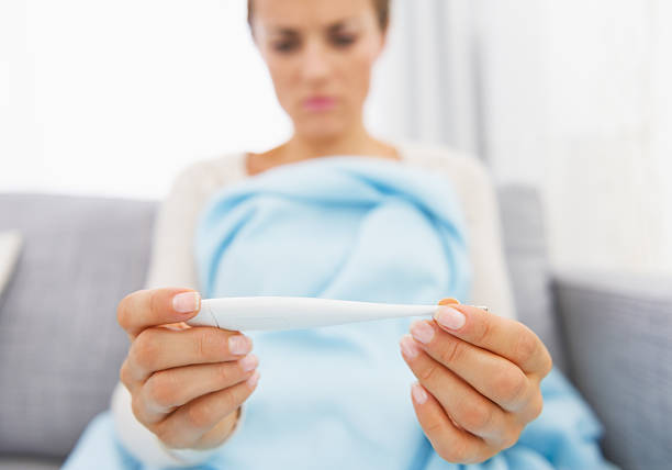 istock Young woman looking on thermometer. Closeup 468091217