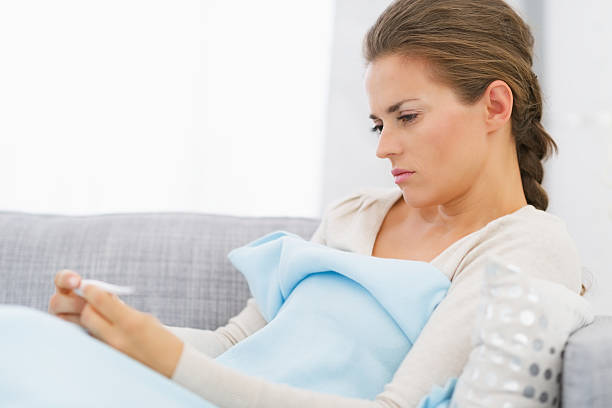 istock displeased young woman looking on thermometer 468094737