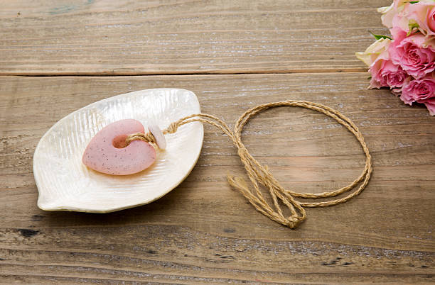istock Heart shaped necklace on the plate with roses 468095582