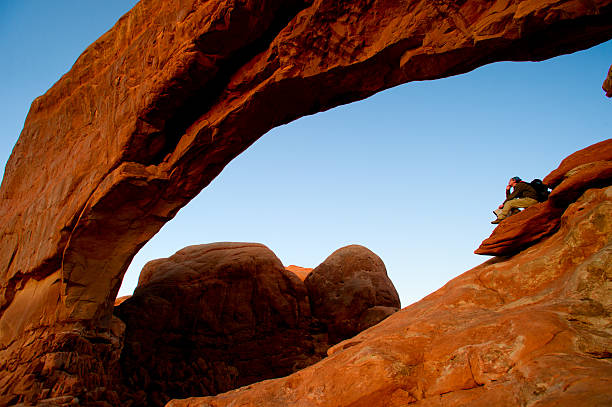 istock Male hiker  under arch looking at view 468095764