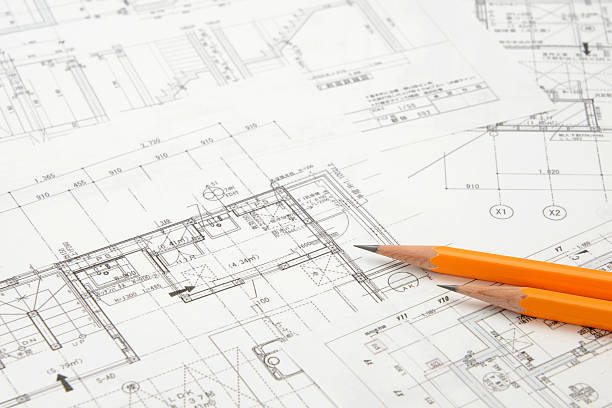 istock House model and pencils on blueprint 468098274