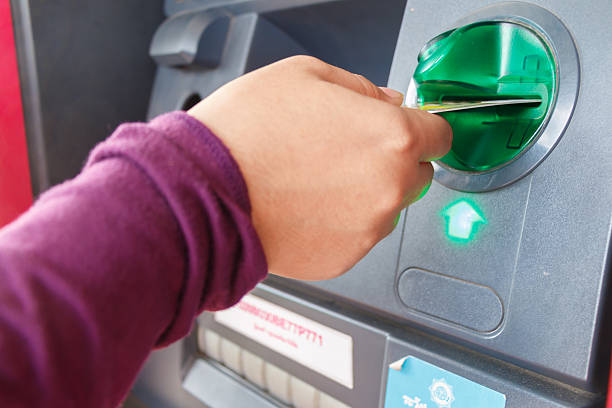 istock ATM close-up with woman hand 468098392