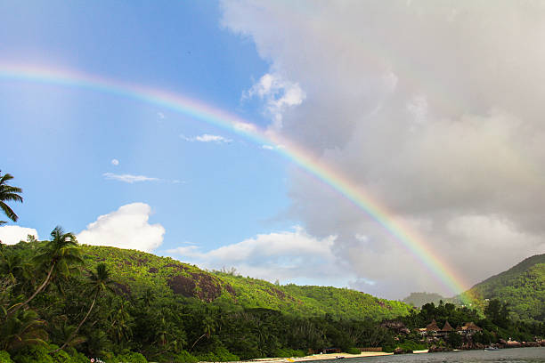 istock Rainbow over tropical island and white beach at Seychelles 468099627