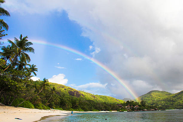 istock Rainbow over tropical island and white beach at Seychelles 468099669
