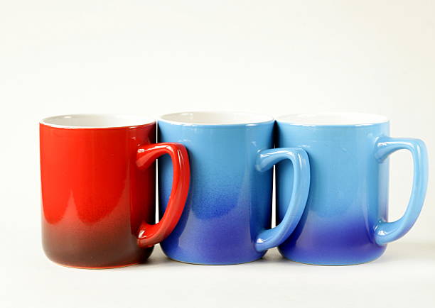 istock three colorful coffee mugs (blue, red) on a white background 468100527