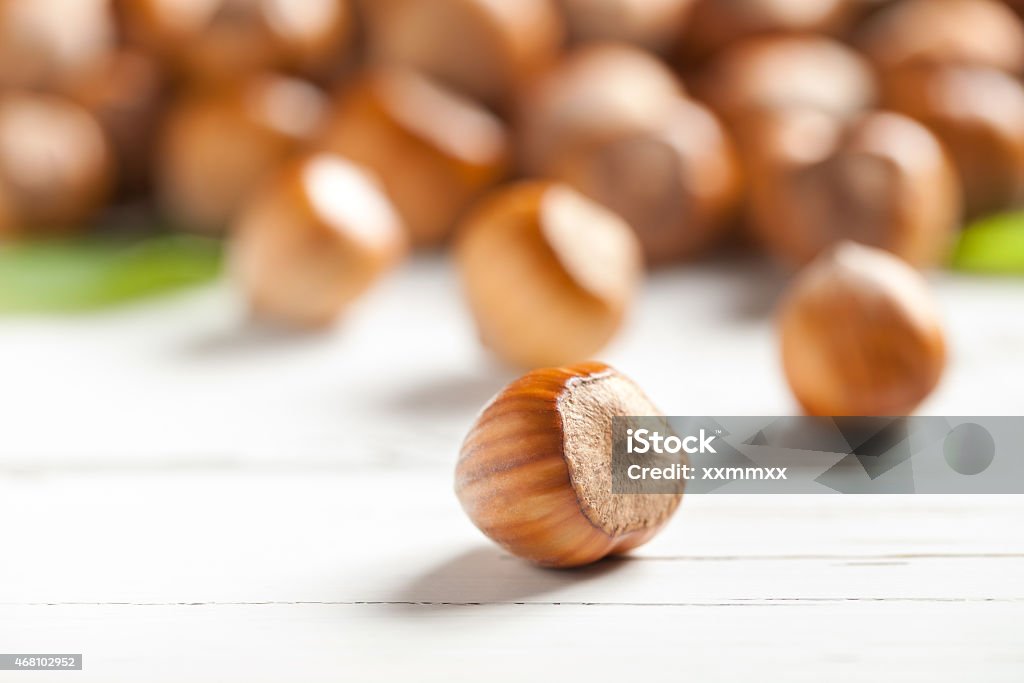 Hazelnut on white table Close up of hazelnuts on white table. This file is cleaned and retouched. 2015 Stock Photo