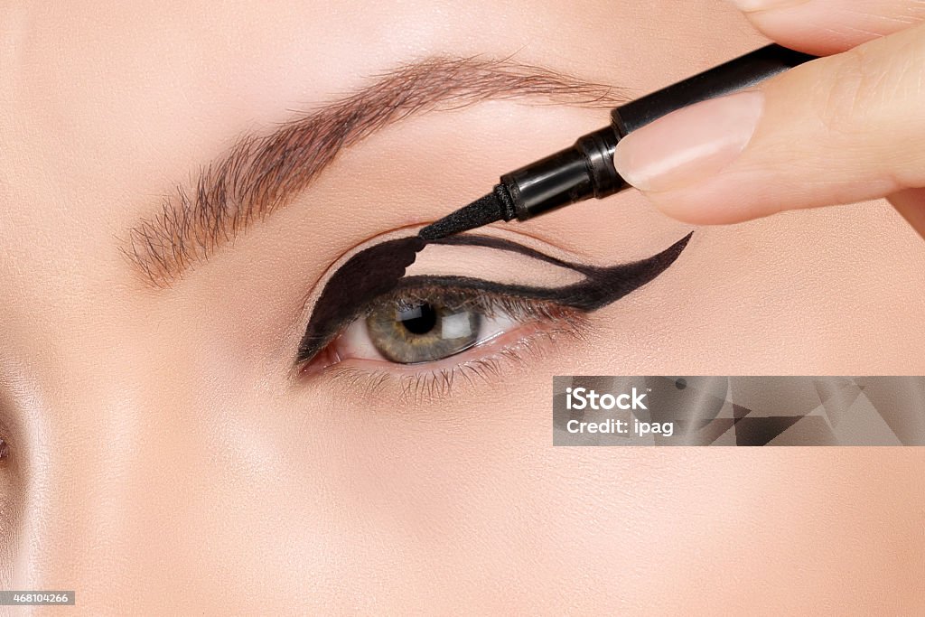 Beautiful model applying foundation with a brush 2015 Stock Photo