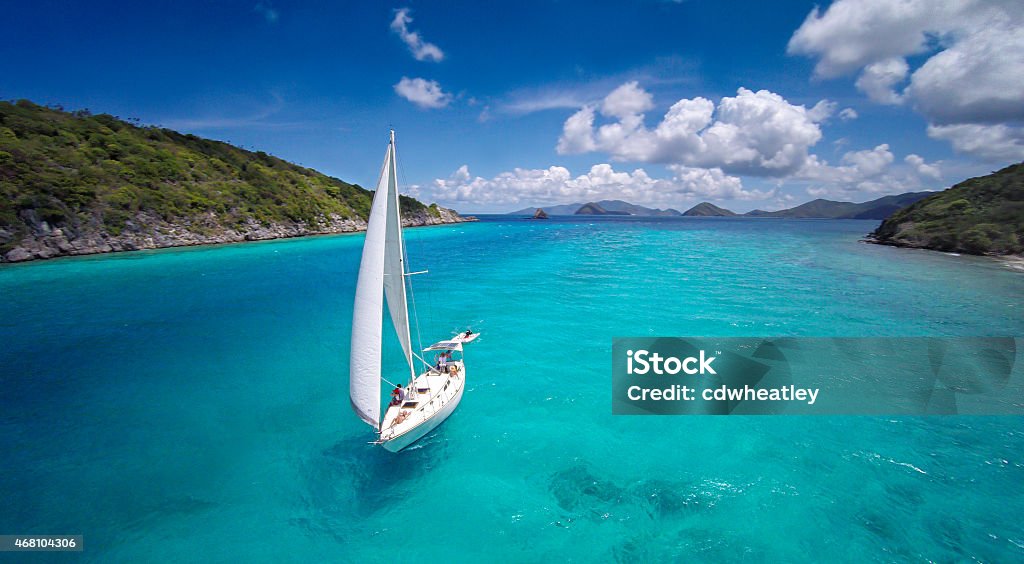 aerial view of a sloop sailing through the Caribbean aerial view of a sloop under full sails sailing through the Caribbean Sailboat Stock Photo