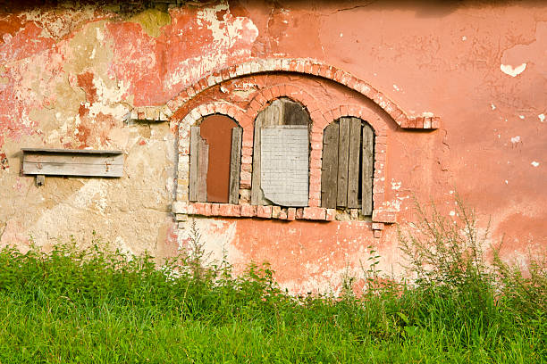 historical  manor ruins windows and cracked wall