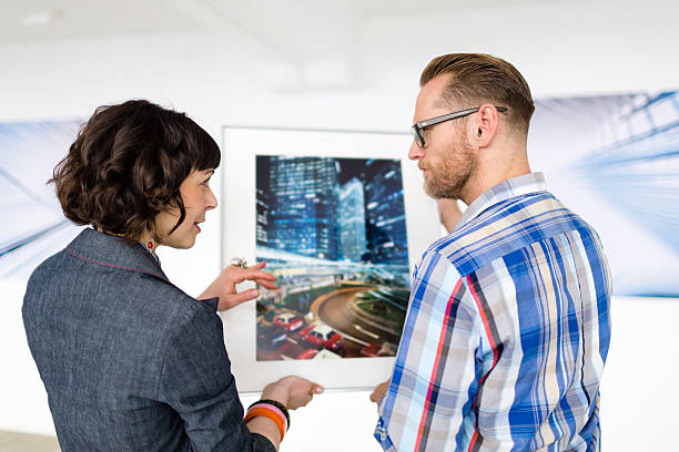 istock Artist Showing Female Gallery Owner His Work 468107112