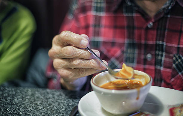 istock Elderly Man Hand Eating Soup With Spoon 468115390