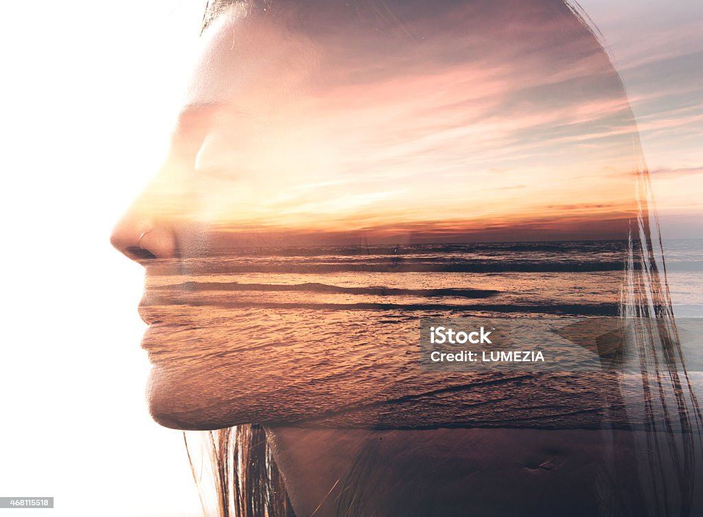 Double exposure portrait of a woman and the beach Double exposure portrait of a woman combined with photograph of nature Multiple Exposure Stock Photo