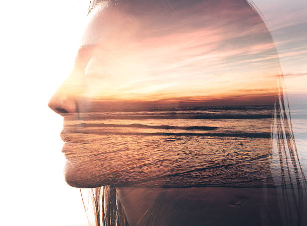 Double exposure portrait of a woman and the beach Double exposure portrait of a woman combined with photograph of nature sunrise timelapse stock pictures, royalty-free photos & images