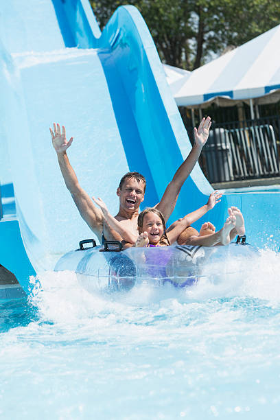 istock Father and daughter on water slide 468117178