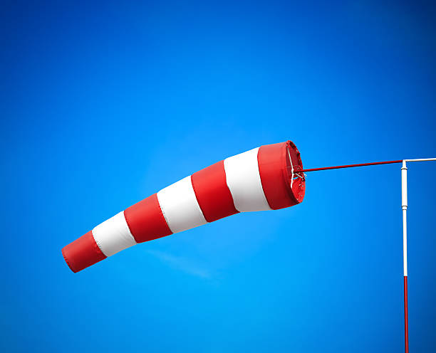 istock Red And White Striped Windsock On The Airport 468119598