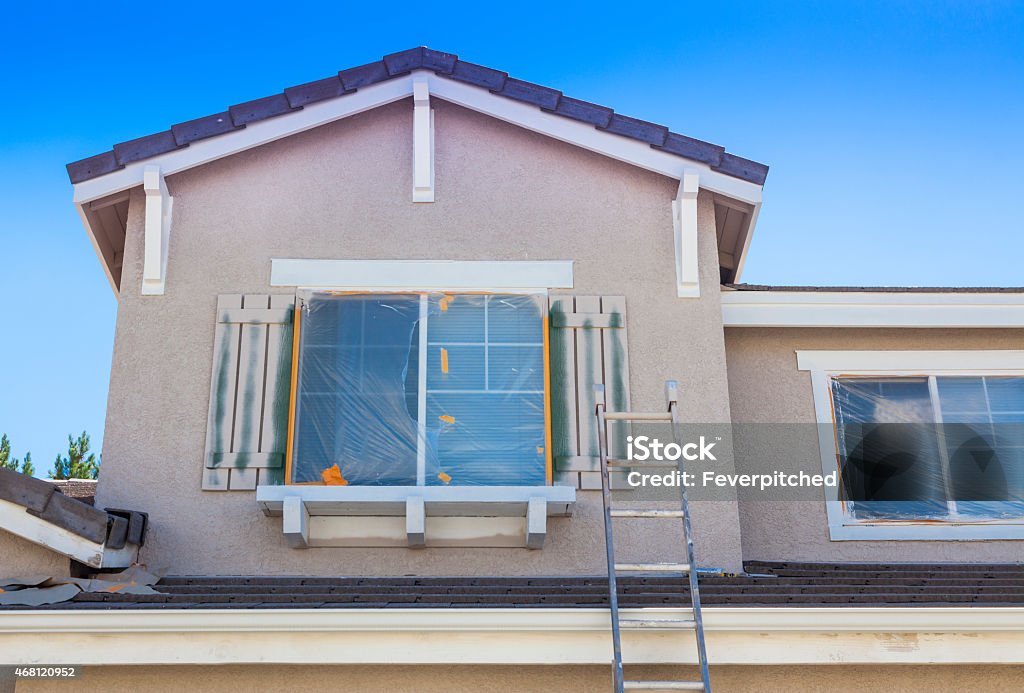 Ladder Leaning Up Against A House Ready For New Paint Construction Ladder Leaning Up Against A House Ready For New Paint. Outdoors Stock Photo