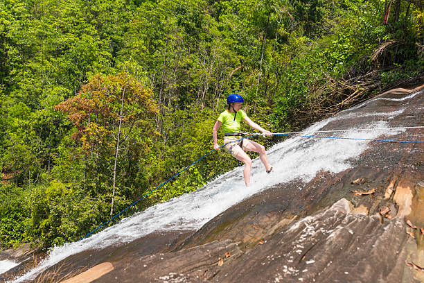 istock A woman doing waterfall abseiling with rope 468124678