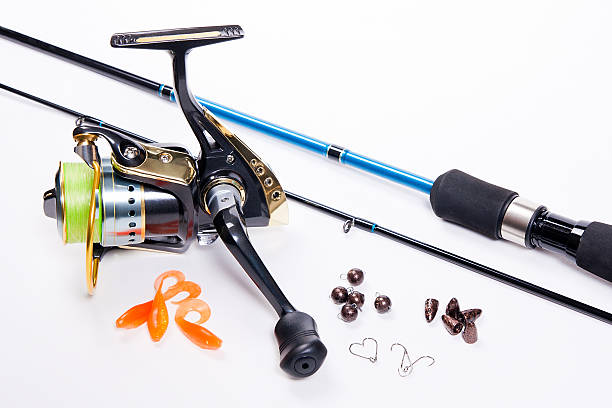 istock Fishing rod and reel with silicone baits on white. 468124958
