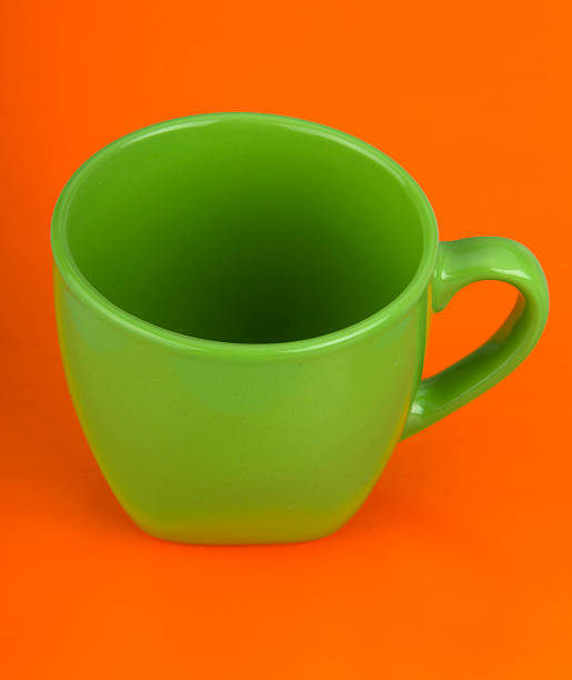 Green Cup On Orange Background stock photo