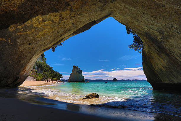 View of Cathedral Cove looking out onto ocean and blue sky Cathedral Cove / New Zealand coromandel peninsula stock pictures, royalty-free photos & images