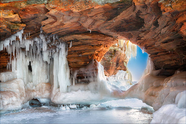 Ice Arch A beautiful natural arch on Lake Superior covered in ice brightly lit winter season rock stock pictures, royalty-free photos & images