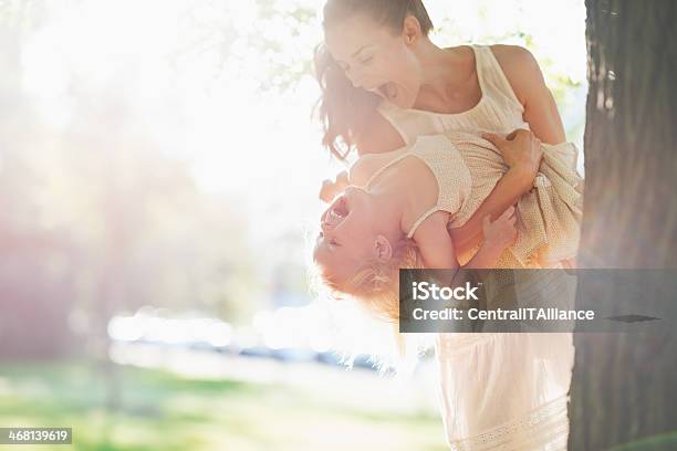 Happy Mother And Baby Having Fun Near Tree Stock Photo - Download Image Now - Adult, Baby - Human Age, Baby Girls