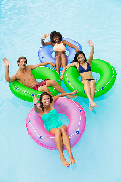 istock Teenage friends floating on innertubes 468140366