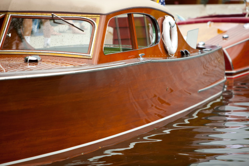 A beautifully restored Chris Craft powerboat is moored at a dock during a Wooden Boat Show in Sandpoint, Idaho.