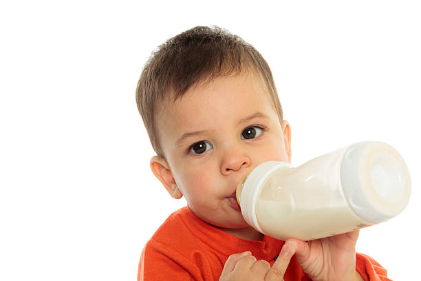 istock Pretty baby boy drinking milk from bottle 468143380