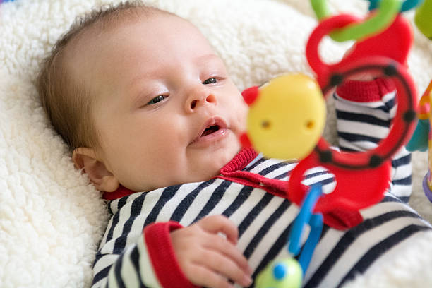 istock Happy baby playing with hanging toys 468143448