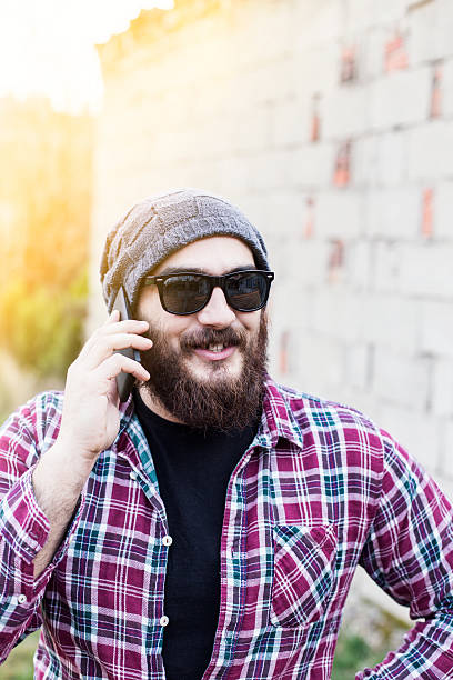 istock Handsome hipster modern man using smart phone in the city 468144384