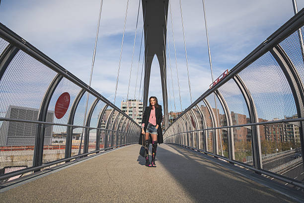 istock Beautiful young brunette posing on a bridge 468144596