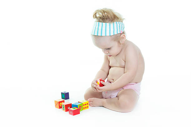 istock blond baby Play block in studio 468144862