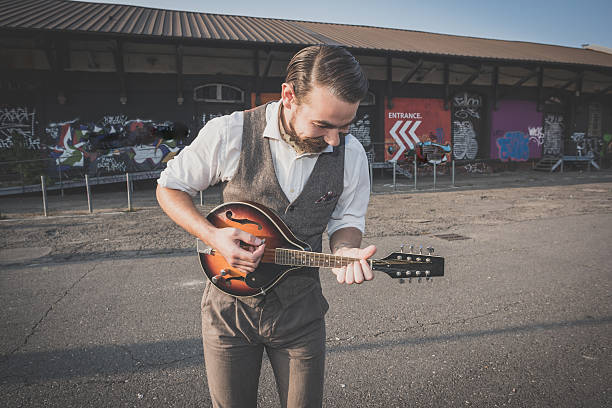 istock handsome big moustache hipster man playing mandolin 468144894
