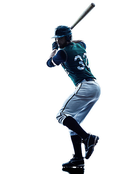 Man with baseball bat swinging one caucasian man baseball player playing  in studio  silhouette isolated on white background batsman photos stock pictures, royalty-free photos & images